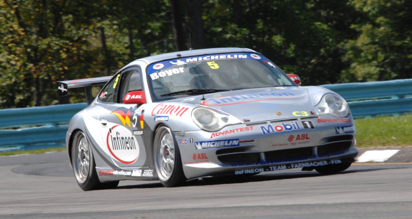 Silver Porsche 911 GT3 Cup, number 5, cornering at Watkins Glen